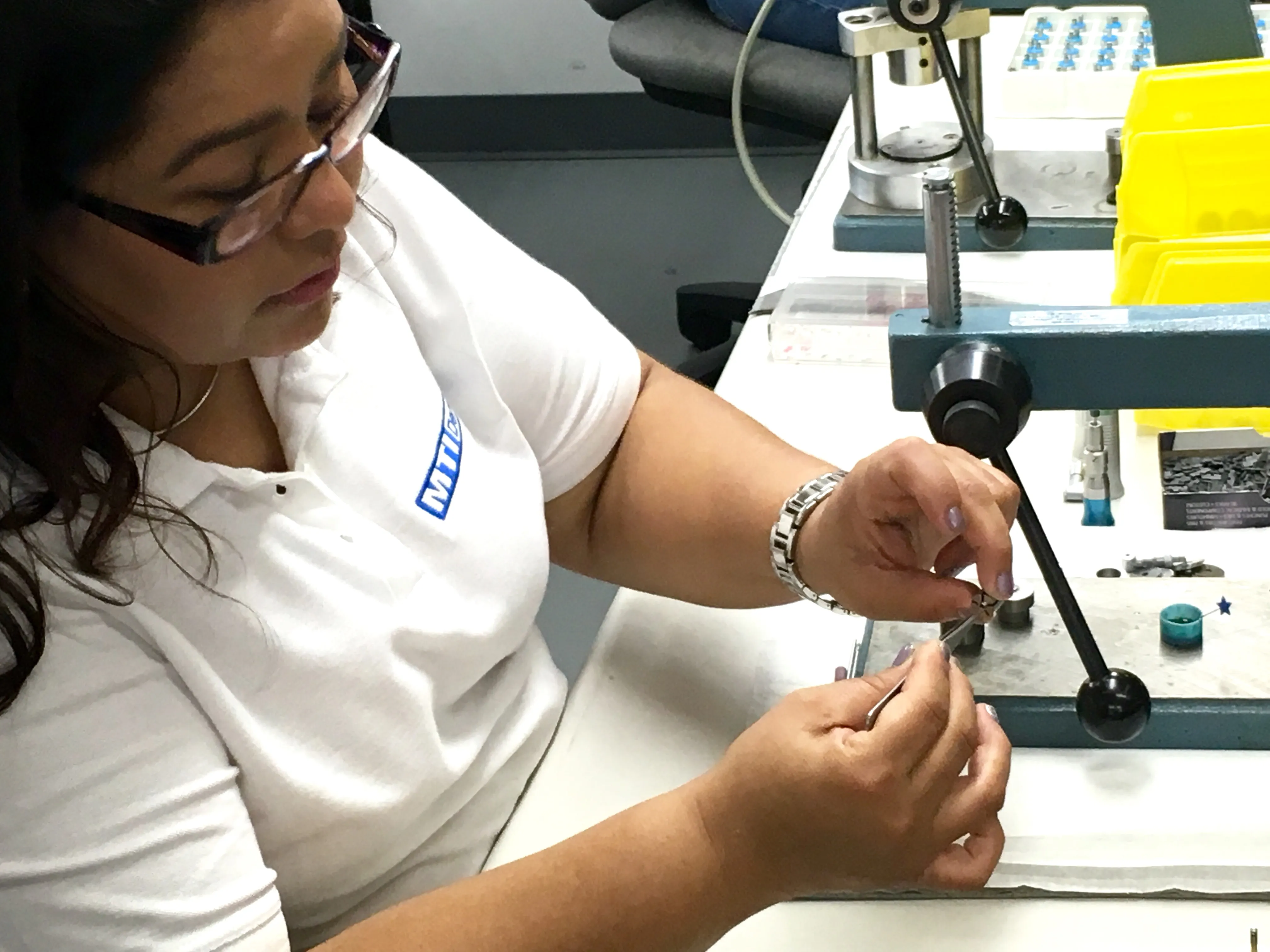 Assembling small precision parts at a bench press