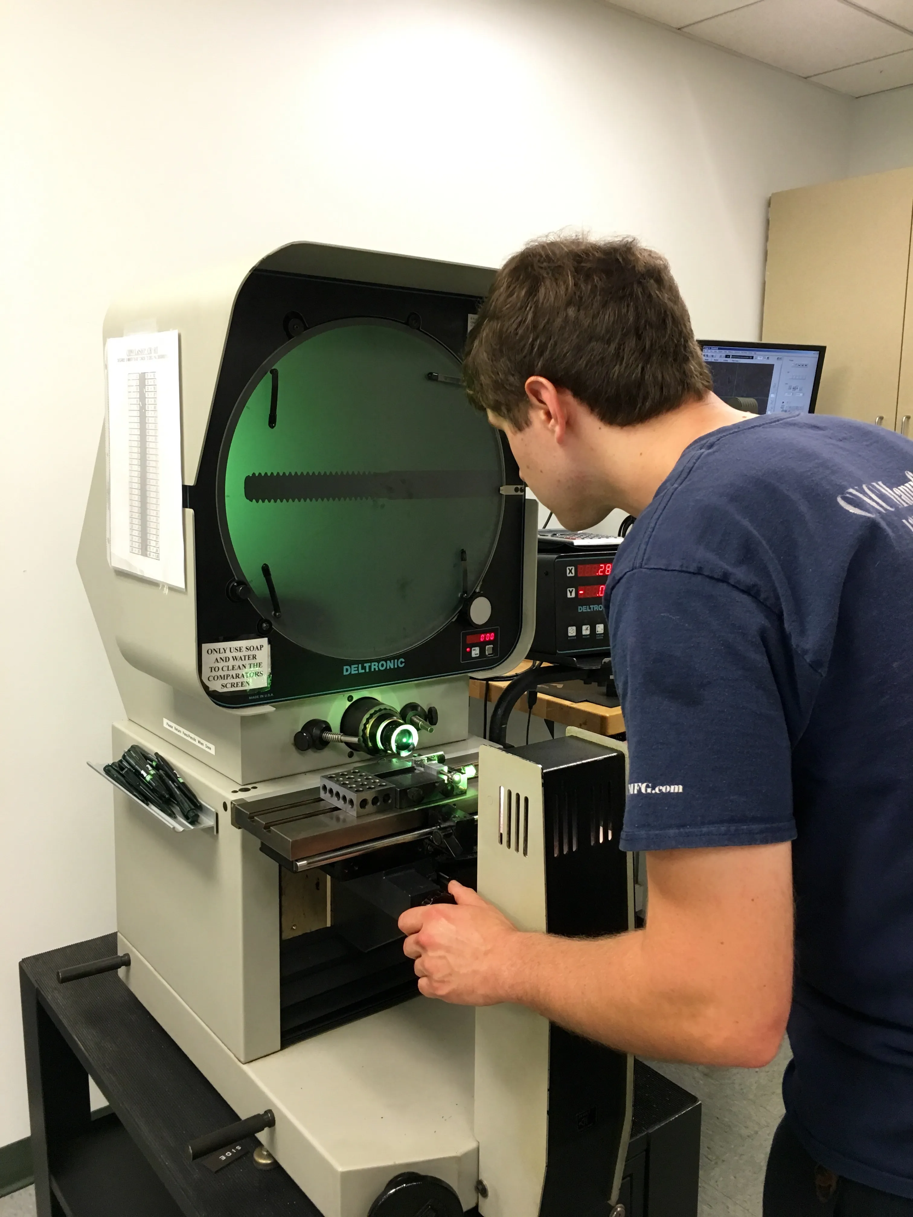 Checking a part profile on an optical comparator — profile-critical features get verified, in support of AS9100D and ISO 9001:2015